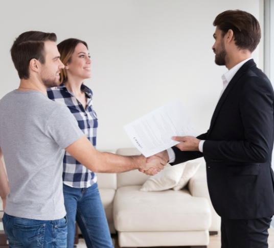 young couple signing rental contract with real estate agent in Melbourne